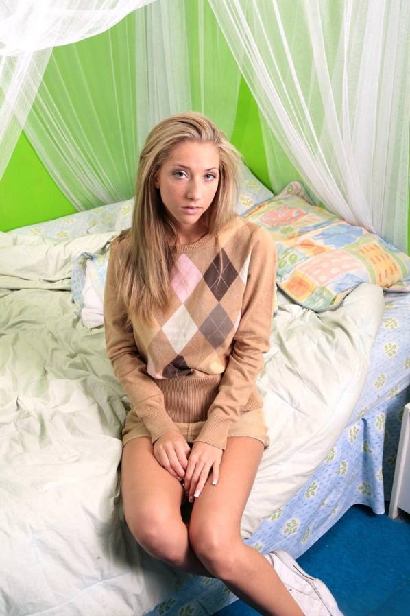 Naked blonde with huge tits shows off shaved pussy