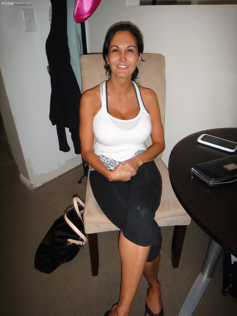 Busty MILF Ava Adams strips and flaunts her big tits