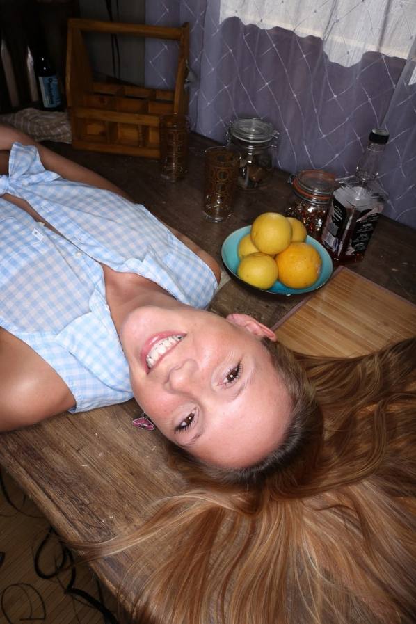 Freckled cutie Hollie Mack bares her small tits on the table