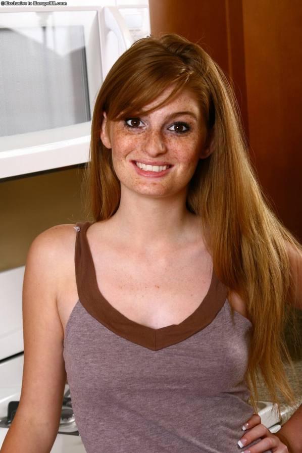 Naked redhead Faye shows her pussy in kitchen
