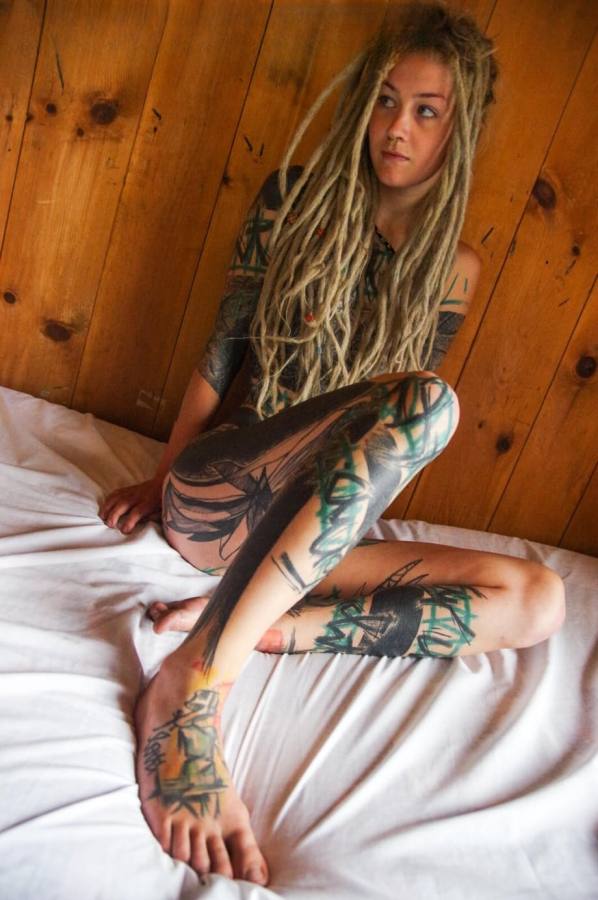 Naked tattooed slut sucks a hard cock
