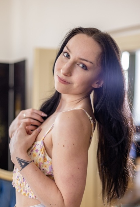 Bella Angel strips nude on sofa, fingers pussy