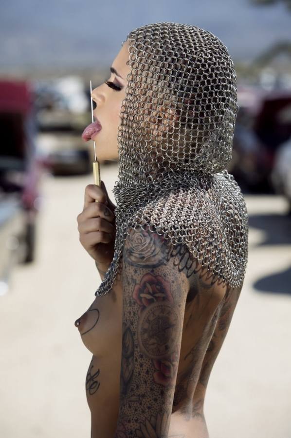 Outdoors nude, inked bald Leigh Raven shows small tits